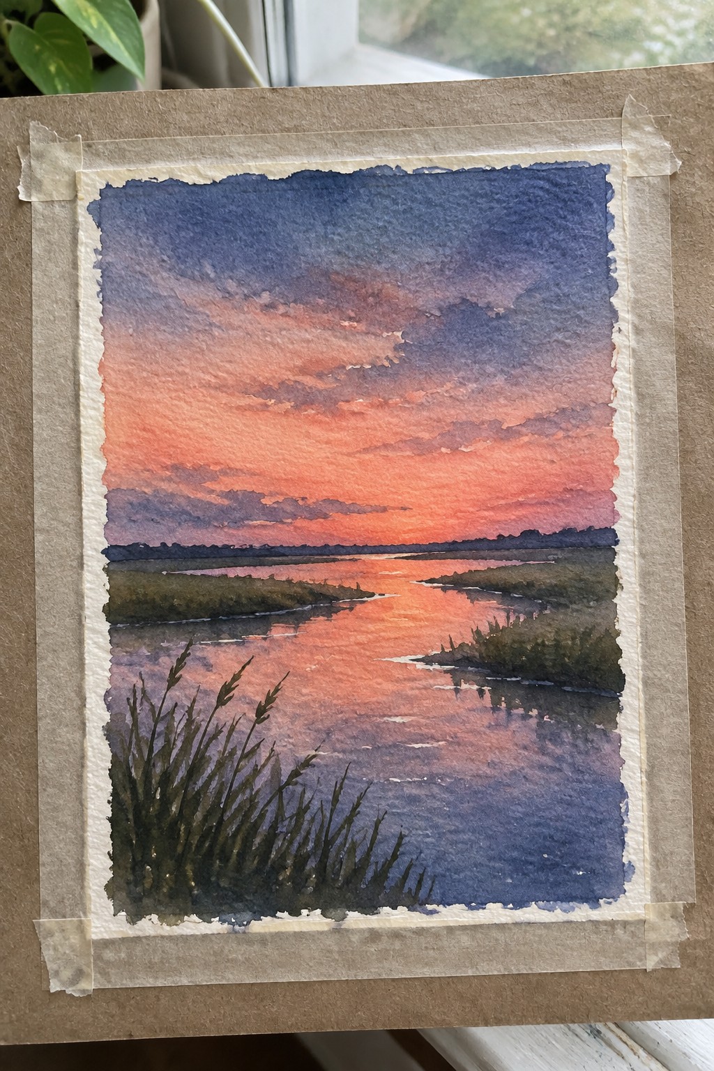 Watercolor sunset over reflective marsh river with orange-purple sky and foreground grasses