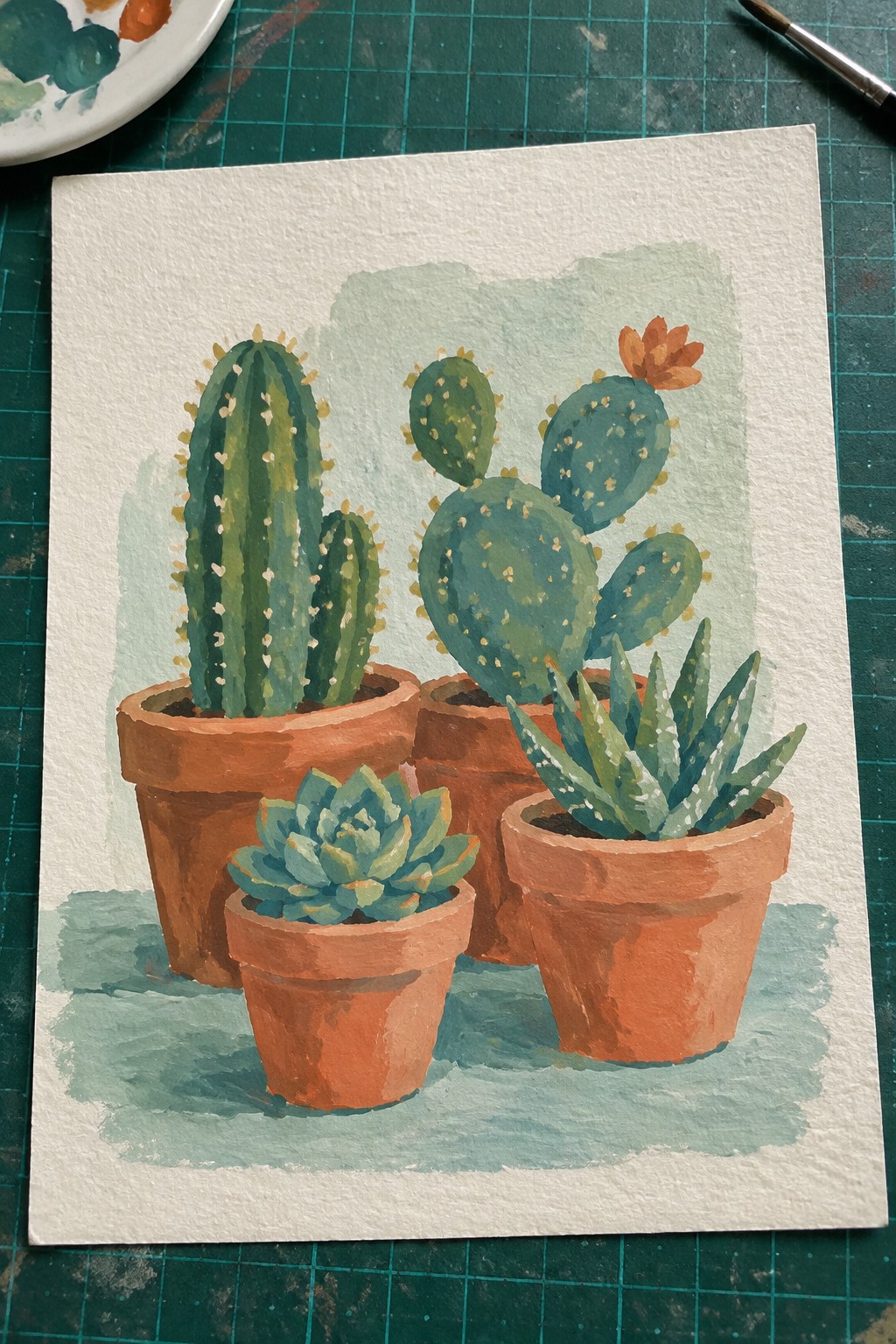 Watercolor painting of cacti and succulents in terracotta pots on green mat