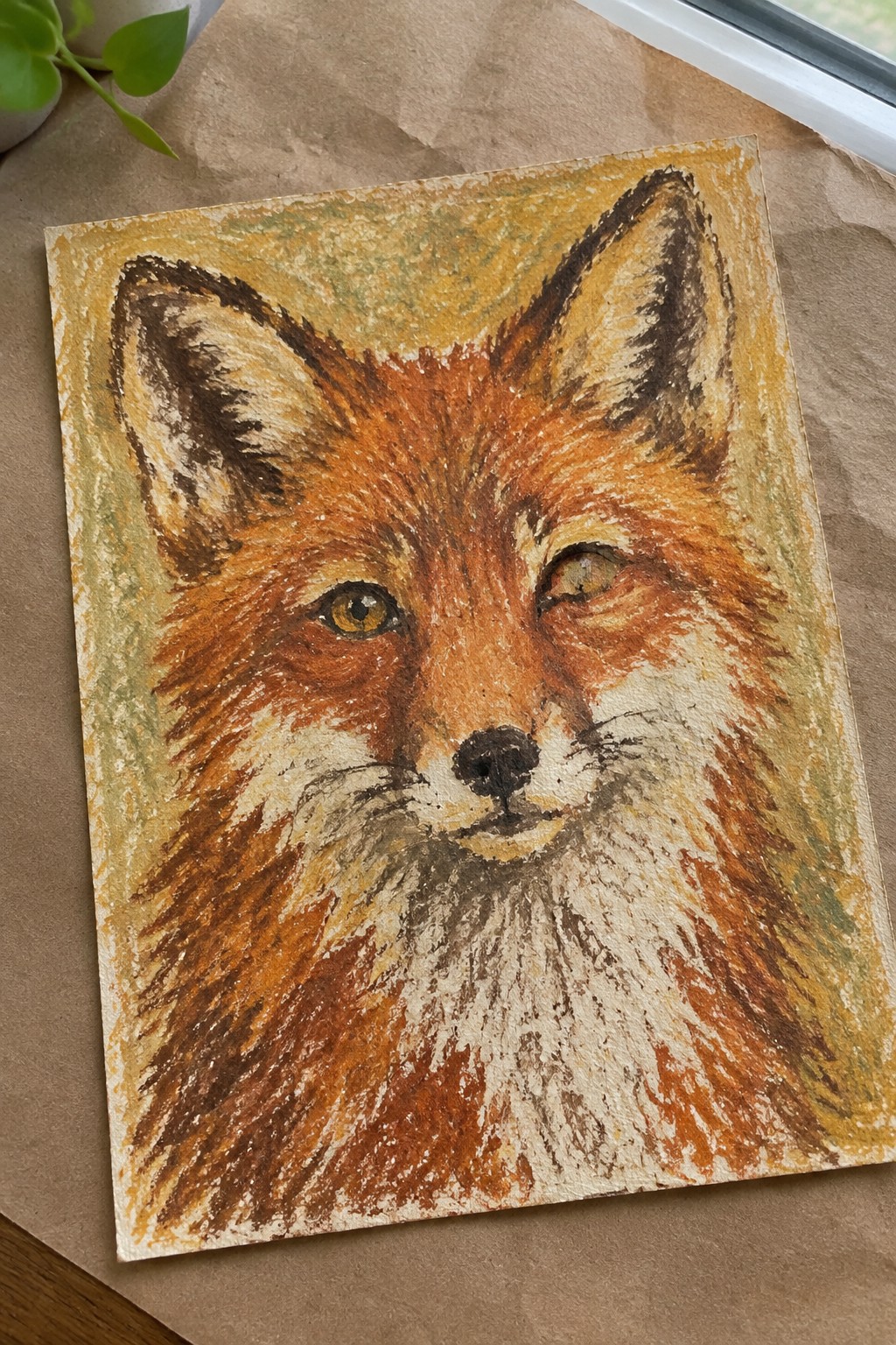 Close-up pastel painting of a fox with orange fur and golden eyes