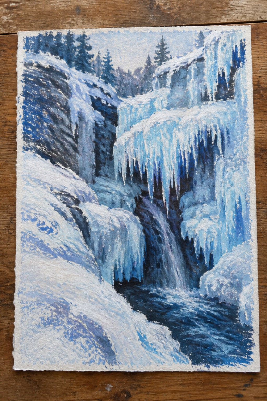 Watercolor of frozen blue waterfall with hanging icicles on snowy cliffs and dark stream
