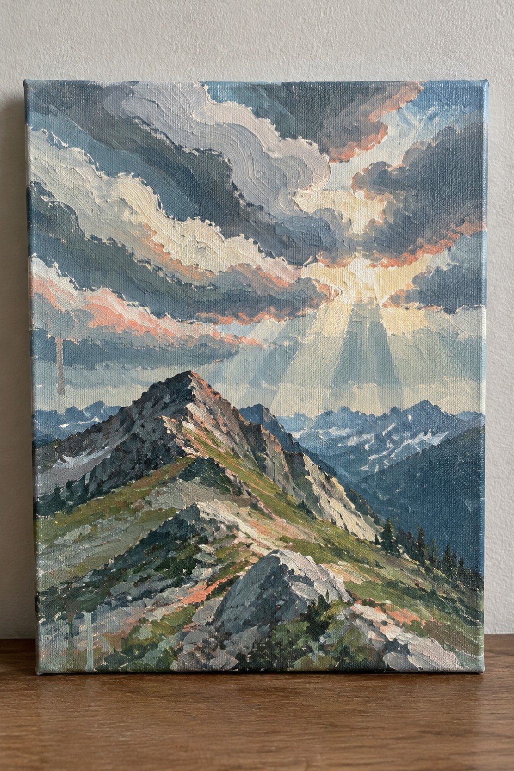 Rugged mountain peaks beneath dramatic stormy clouds with golden sun rays piercing through.